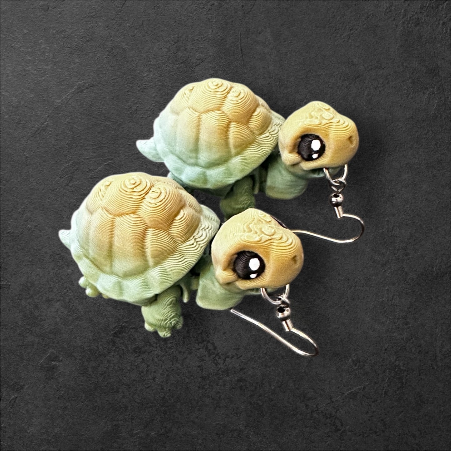 Turtle-shaped earrings on a dark textured background