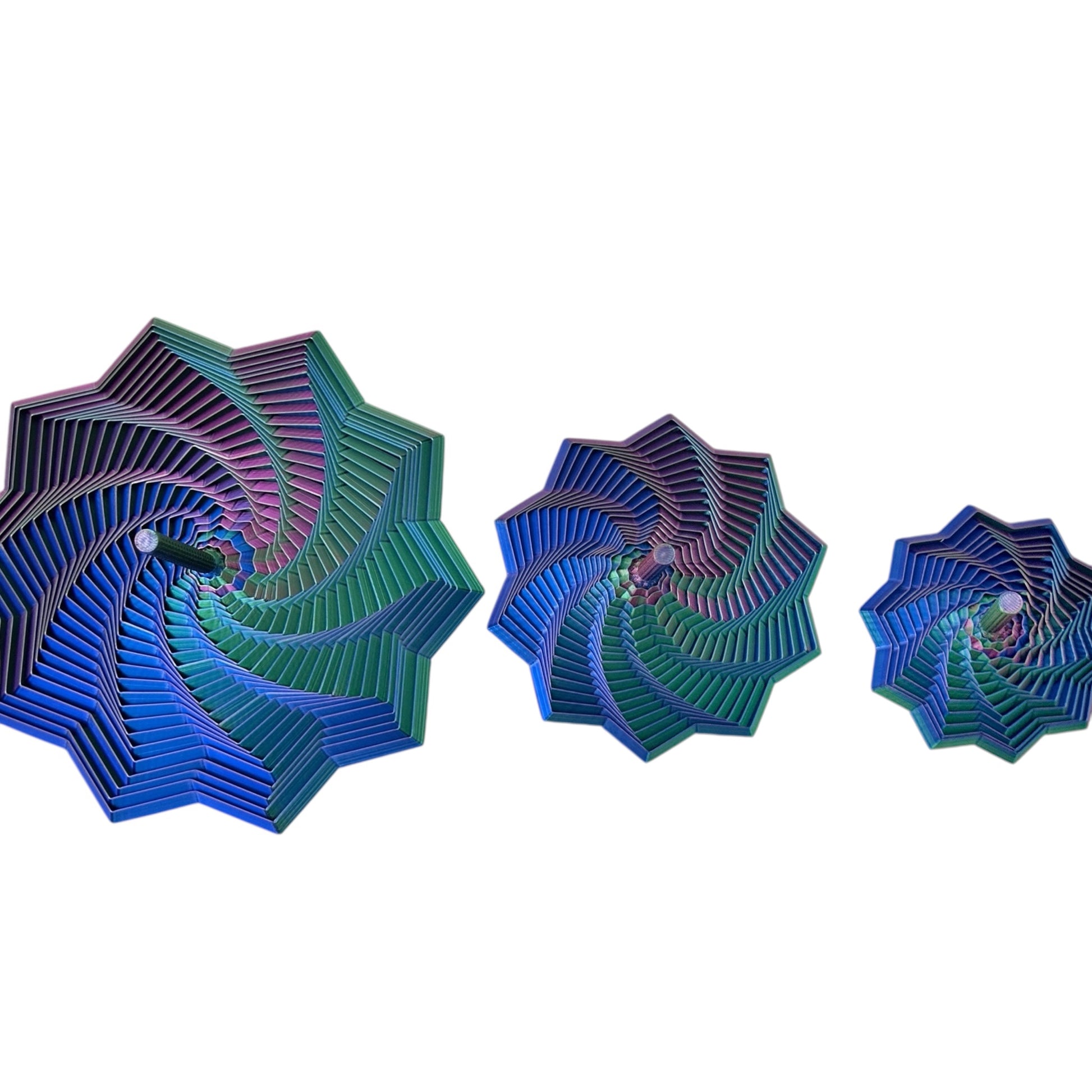 Three 3D printed star blue and green geometric spiral designs with a handle on a white background
